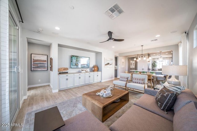 12239 W Caraveo Pl, Peoria, AZ 85383 - living area with a ceiling fan, light wood-type flooring, baseboards, and recessed lighting