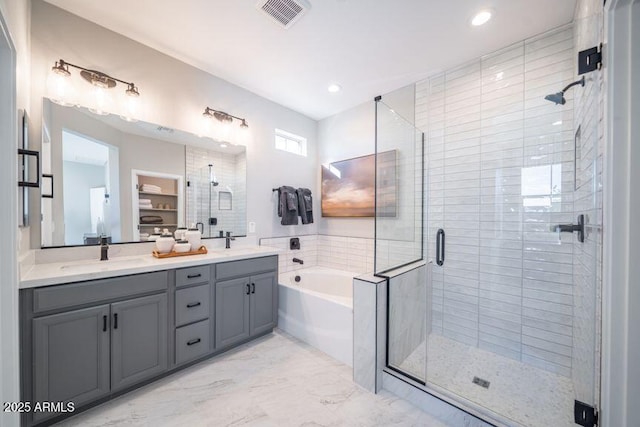 12239 W Caraveo Pl, Peoria, AZ 85383 - full bathroom featuring a shower stall, a garden tub, marble finish floors, double vanity, and recessed lighting