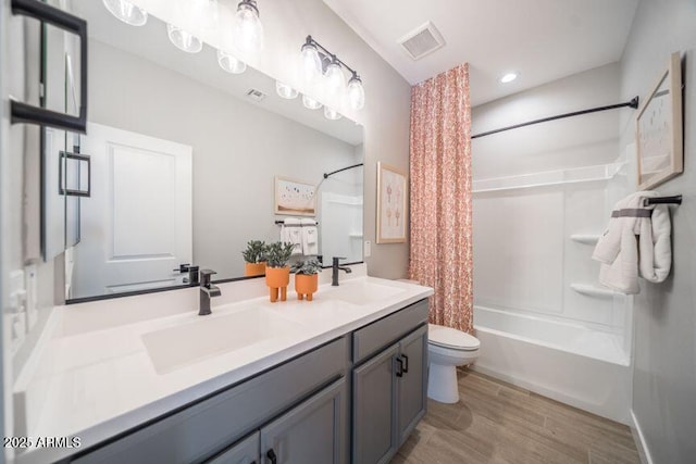 12239 W Caraveo Pl, Peoria, AZ 85383 - bathroom featuring toilet, shower / bathtub combination with curtain, double vanity, wood finished floors, and recessed lighting