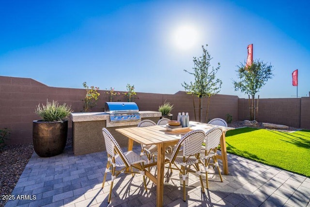12239 W Caraveo Pl, Peoria, AZ 85383 - view of patio featuring area for grilling, a fenced backyard, and outdoor dining area