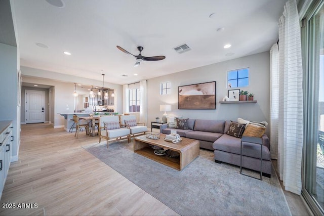 12239 W Caraveo Pl, Peoria, AZ 85383 - living room with plenty of natural light, ceiling fan, light wood-style flooring, recessed lighting, and baseboards