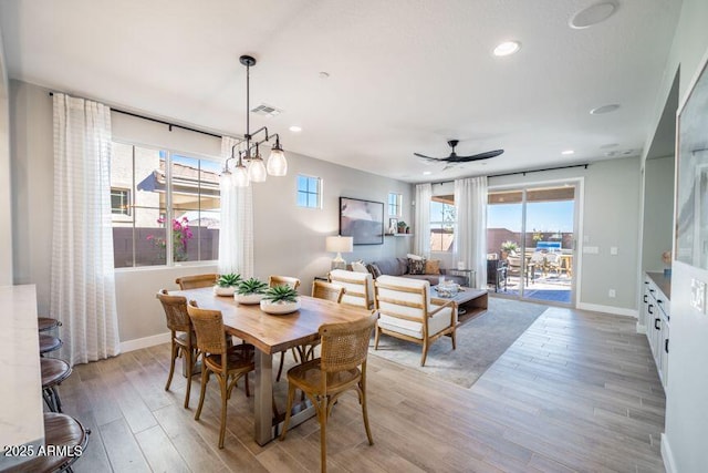 12239 W Caraveo Pl, Peoria, AZ 85383 - dining area featuring a ceiling fan, baseboards, light wood-style flooring, plenty of natural light, and recessed lighting
