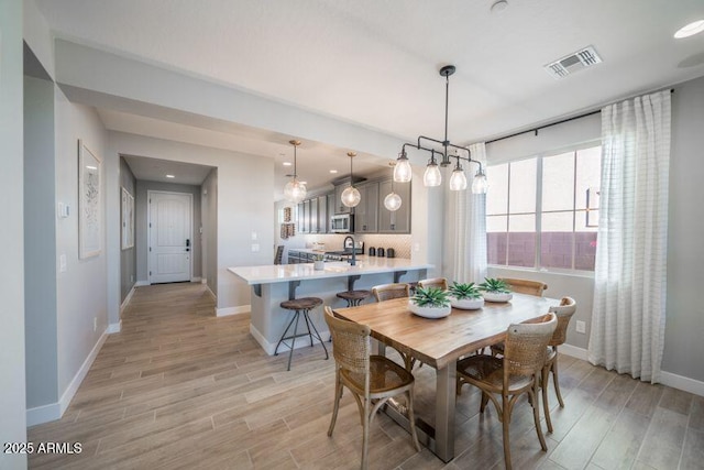 12239 W Caraveo Pl, Peoria, AZ 85383 - dining space featuring light wood-style floors, baseboards, and recessed lighting