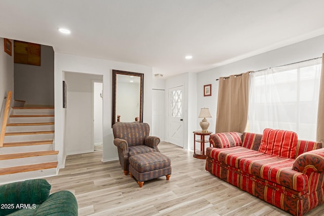 living area featuring light wood finished floors, stairway, and recessed lighting