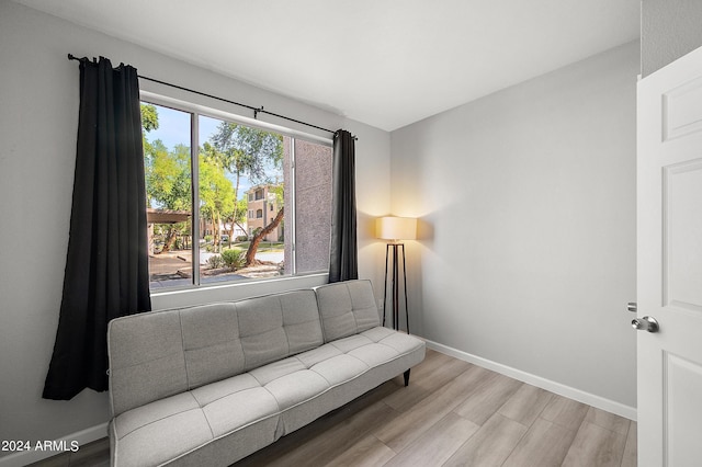 living area featuring wood finished floors and baseboards