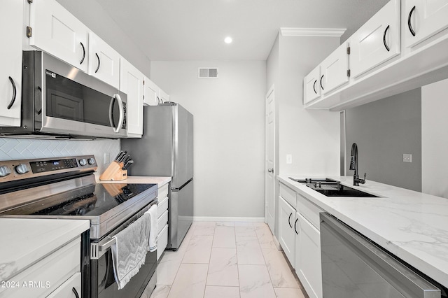 kitchen featuring stainless steel appliances, a sink, visible vents, baseboards, and marble finish floor