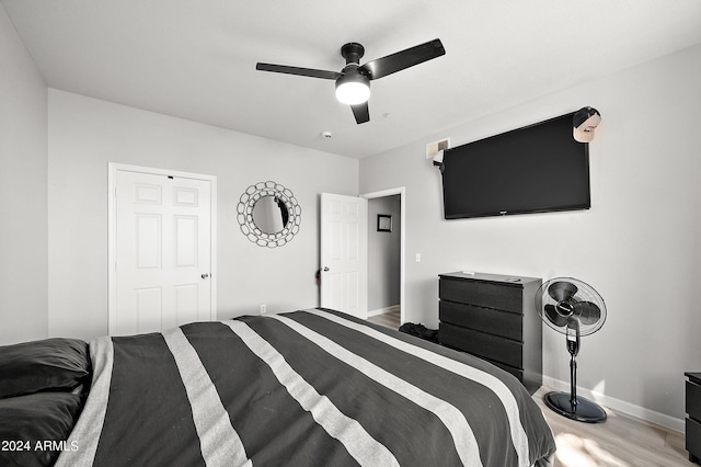 bedroom featuring ceiling fan, wood finished floors, and baseboards