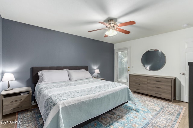 bedroom with ceiling fan and light hardwood / wood-style floors