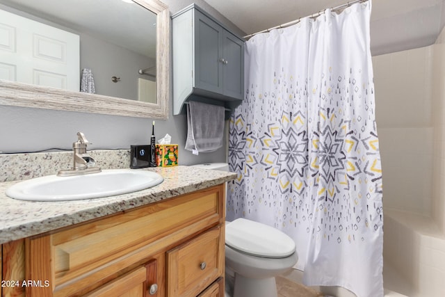 full bathroom featuring shower / tub combo, vanity, and toilet