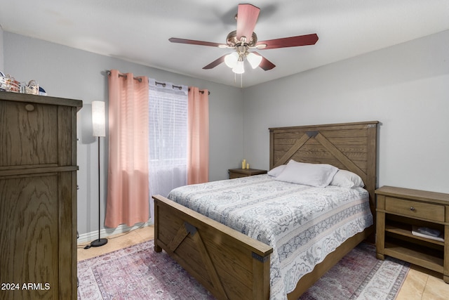 bedroom with ceiling fan and light tile patterned flooring