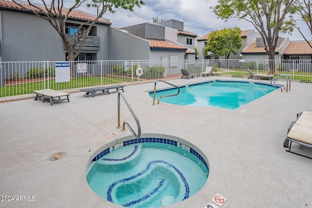 view of pool featuring a patio area and a hot tub