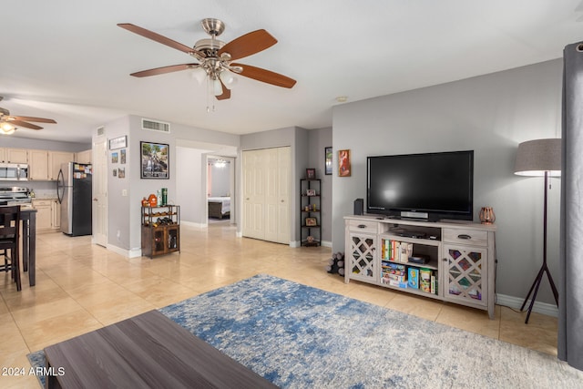 living room with ceiling fan and light tile patterned floors