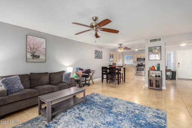 living room with light tile patterned floors and ceiling fan