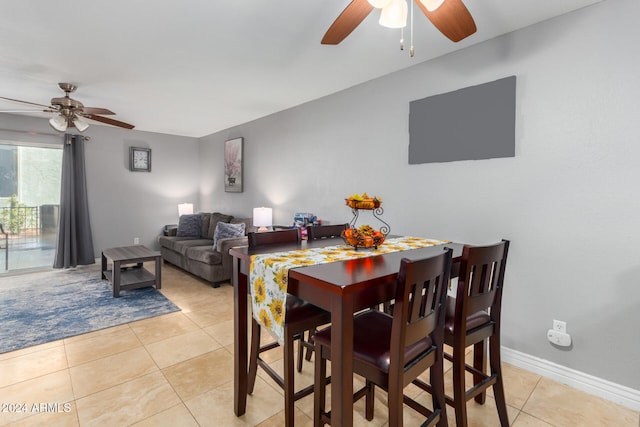 tiled dining space featuring ceiling fan