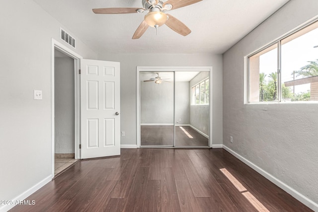 725 S Power Rd Unit 101, Mesa, AZ 85206 - unfurnished bedroom with wood finished floors, a closet, and a ceiling fan