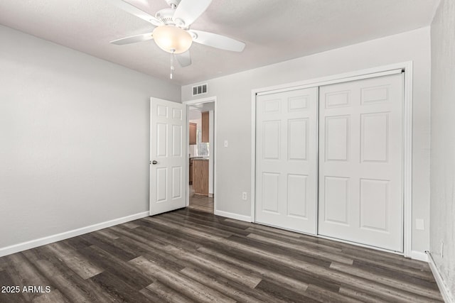 725 S Power Rd Unit 101, Mesa, AZ 85206 - unfurnished bedroom with dark wood-type flooring, a closet, and ceiling fan