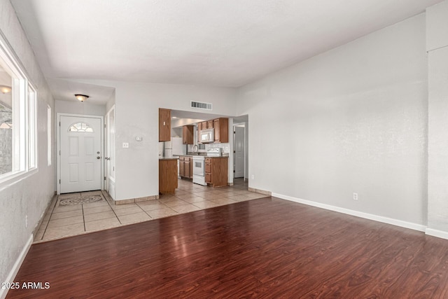 725 S Power Rd Unit 101, Mesa, AZ 85206 - entrance foyer featuring light wood finished floors and vaulted ceiling