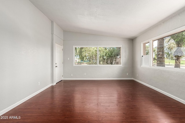 725 S Power Rd Unit 101, Mesa, AZ 85206 - unfurnished room featuring lofted ceiling and dark wood-style flooring
