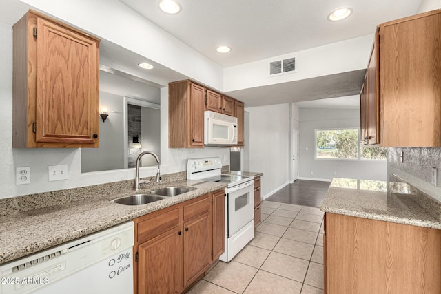 725 S Power Rd Unit 101, Mesa, AZ 85206 - kitchen with white appliances, light tile patterned floors, recessed lighting, light stone counters, and brown cabinetry