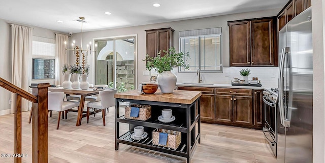 43256 N Hinoki St, Queen Creek, AZ 85140 - kitchen featuring appliances with stainless steel finishes, a sink, dark brown cabinets, light wood-style floors, and recessed lighting