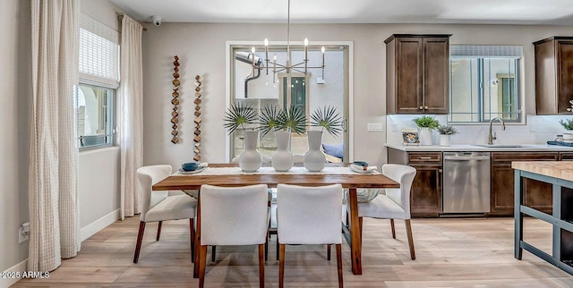 43256 N Hinoki St, Queen Creek, AZ 85140 - dining area with a chandelier, light wood-style flooring, and baseboards