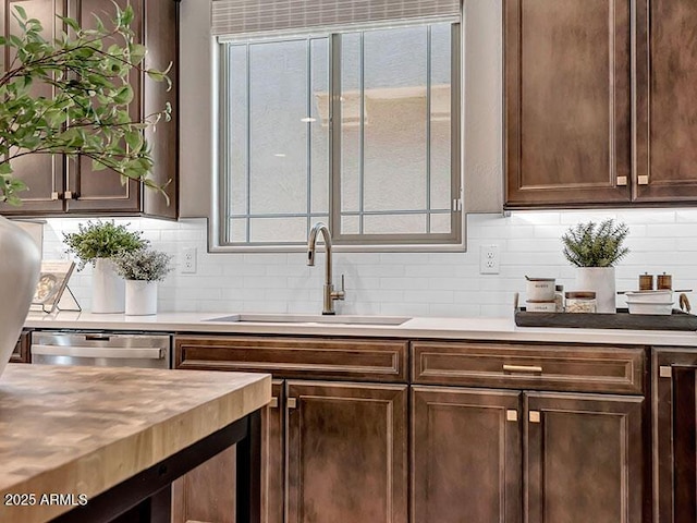 43256 N Hinoki St, Queen Creek, AZ 85140 - kitchen featuring a sink, light countertops, backsplash, dishwasher, and dark brown cabinetry