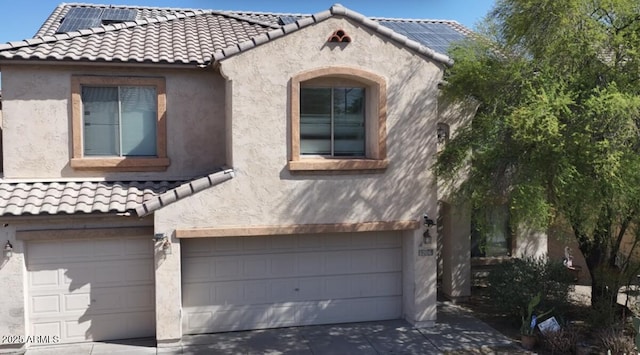 1206 W Pinkley Ave, Coolidge, AZ 85128 - view of front of house featuring stucco siding, driveway, an attached garage, solar panels, and a tile roof