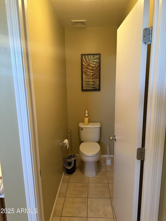 1206 W Pinkley Ave, Coolidge, AZ 85128 - bathroom featuring tile patterned flooring, visible vents, baseboards, and toilet