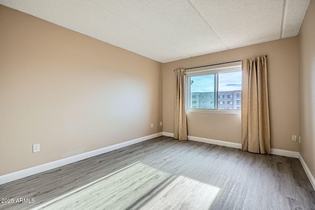 empty room featuring hardwood / wood-style flooring and a textured ceiling