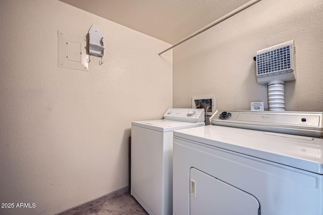 laundry room with light tile patterned floors and washing machine and dryer