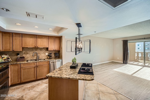 kitchen with sink, a center island, hanging light fixtures, dishwasher, and light stone countertops