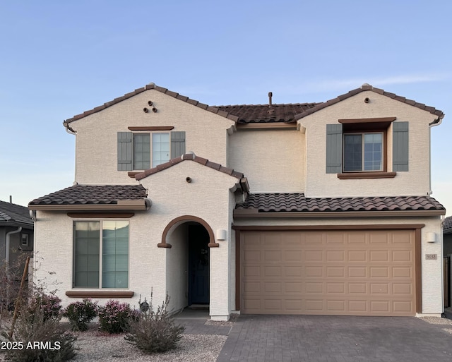 mediterranean / spanish home featuring a garage