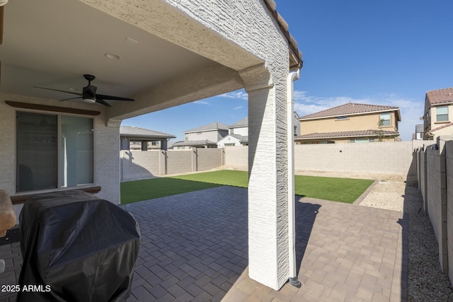 view of patio / terrace featuring ceiling fan and a grill