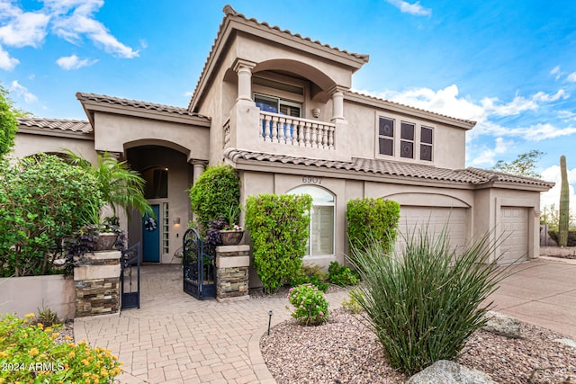 mediterranean / spanish-style home featuring a balcony and a garage