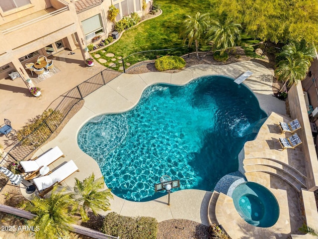 view of swimming pool with an in ground hot tub and a patio