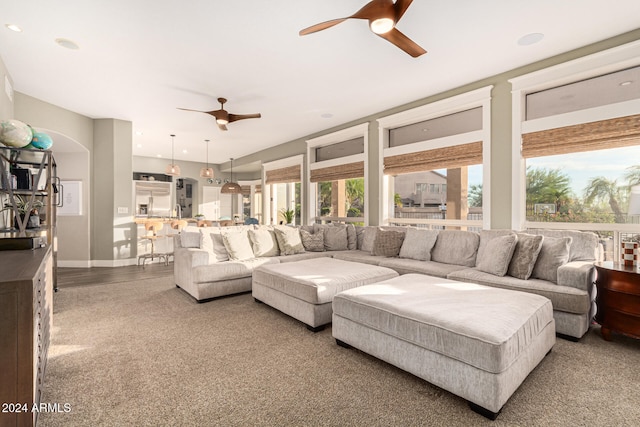 living room featuring ceiling fan and carpet flooring