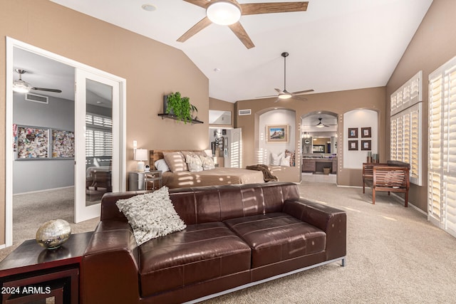 carpeted living room featuring vaulted ceiling, ceiling fan, and a fireplace