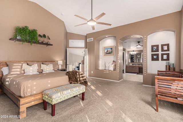 bedroom featuring lofted ceiling, carpet floors, connected bathroom, and ceiling fan