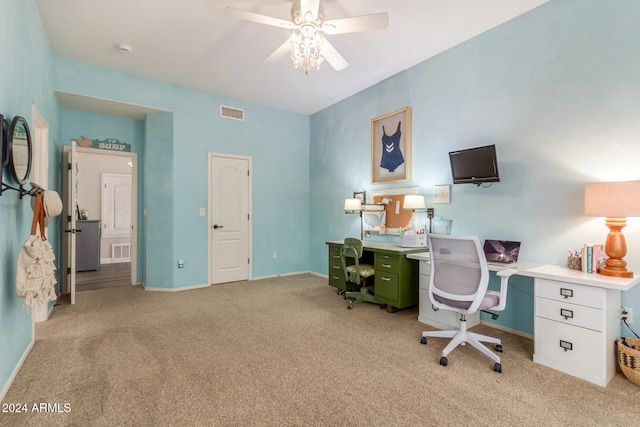 carpeted office space featuring ceiling fan