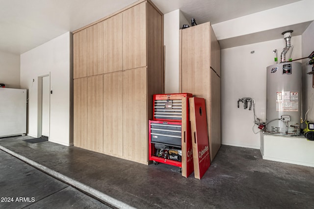 garage with water heater and white fridge