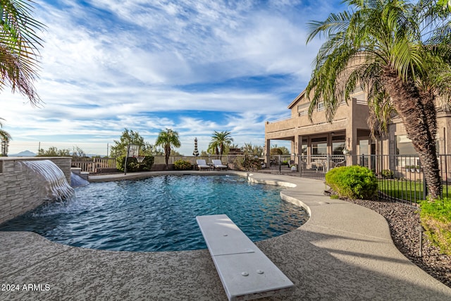 view of swimming pool featuring a diving board, a patio area, and pool water feature