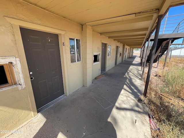 view of exterior entry featuring a patio area