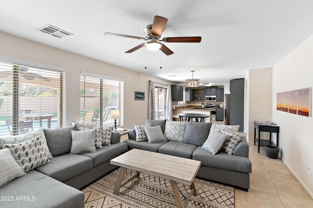 tiled living room with ceiling fan