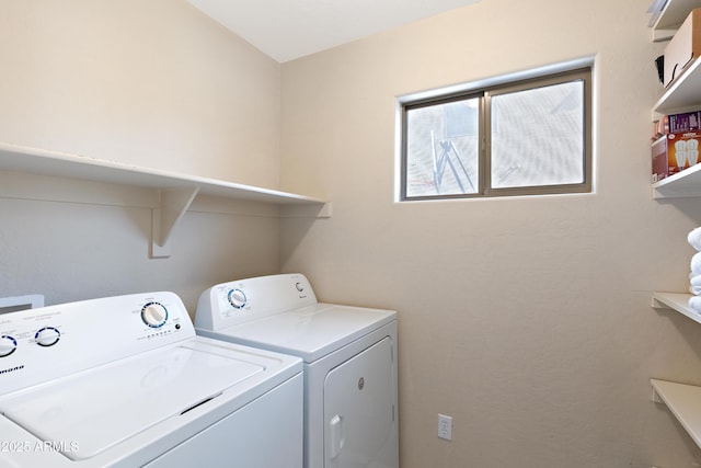 clothes washing area featuring washer and dryer