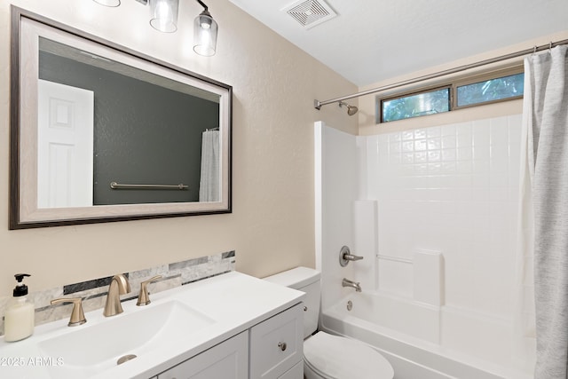 full bathroom featuring vanity, shower / bath combo with shower curtain, and toilet