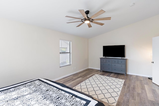 unfurnished bedroom with ceiling fan, lofted ceiling, and light hardwood / wood-style flooring