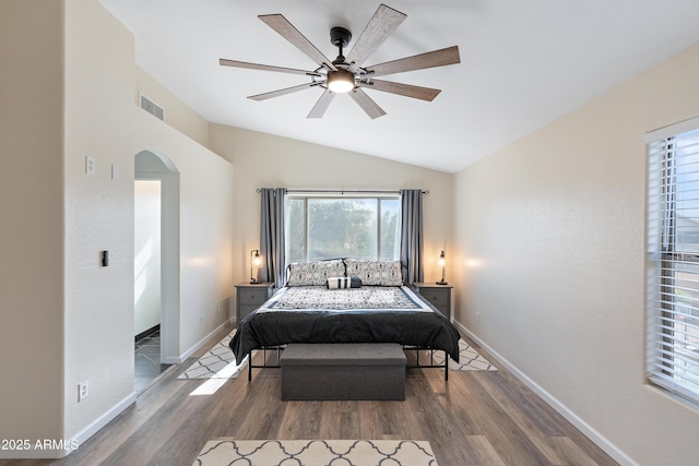 bedroom with hardwood / wood-style flooring, vaulted ceiling, and ceiling fan