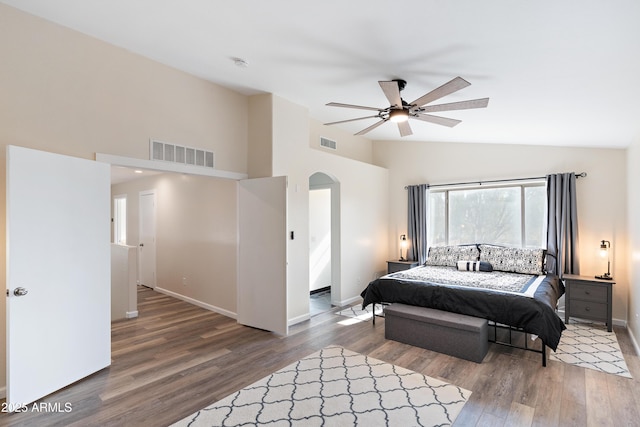 bedroom featuring ceiling fan, wood-type flooring, and high vaulted ceiling