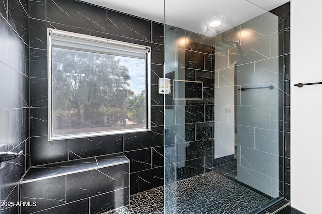 bathroom with a tile shower