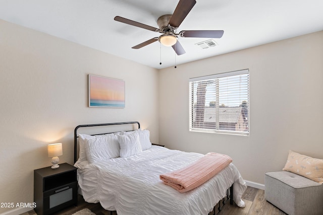 bedroom with ceiling fan and light wood-type flooring